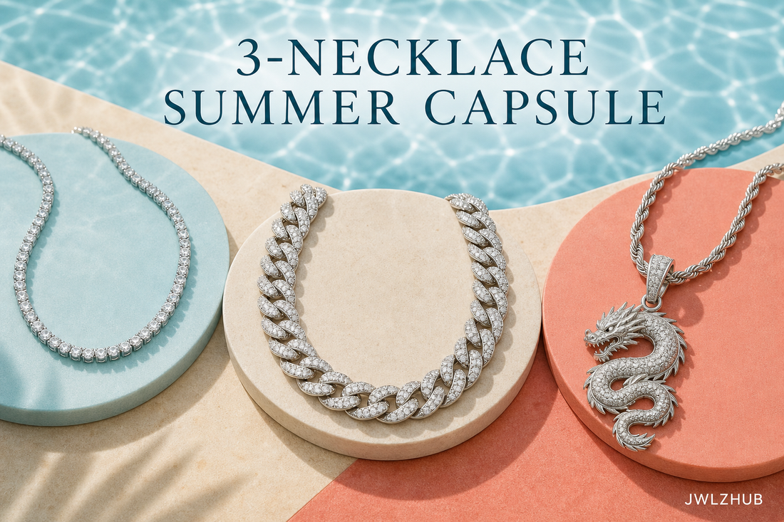 Three-necklace summer jewelry capsule with a tennis chain, iced Cuban chain and dragon pendant on aqua, ivory and coral displays.