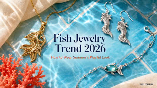 Summer 2026 fish jewelry trend cover with an original sculptural fish pendant, earrings and charm styled on sea-blue ceramic.