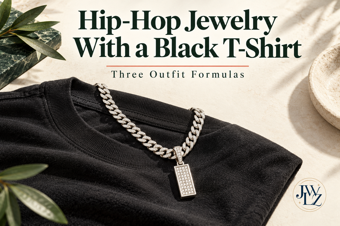 Editorial illustration of a black T-shirt with a silver-tone Cuban chain and rectangular pendant on an ivory styling board