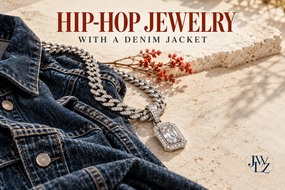 Editorial illustration of an indigo denim jacket with a silver-tone chain and geometric pendant on an ivory tabletop.