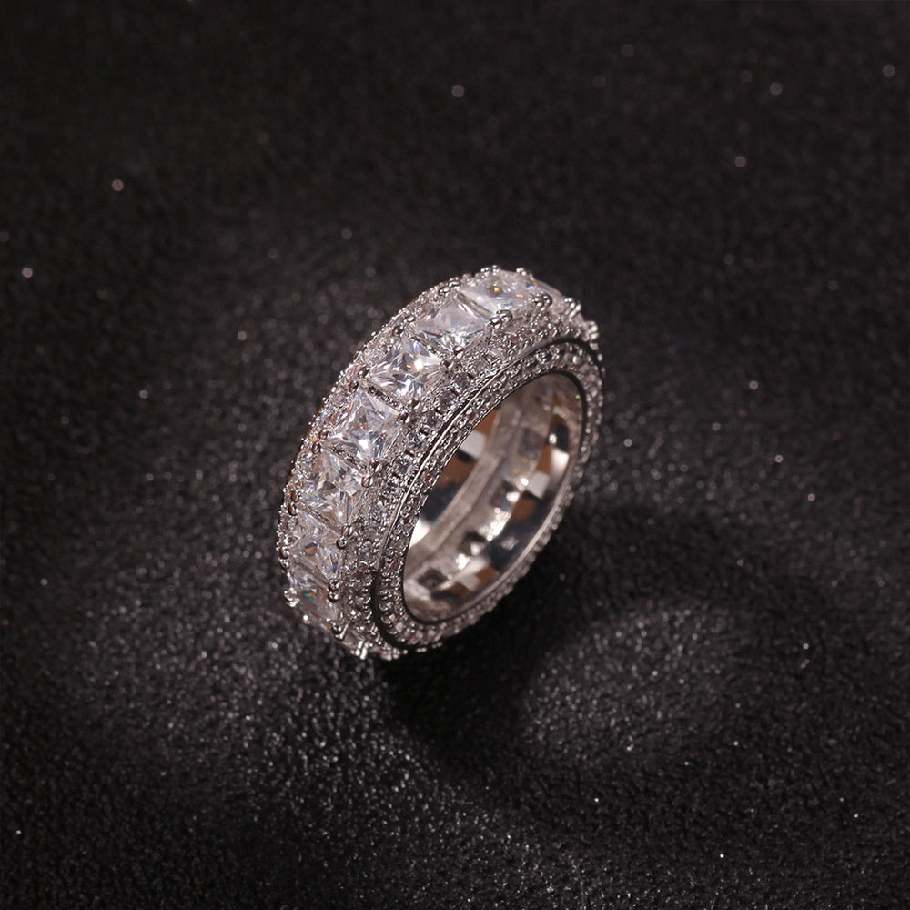 Silver tone round cubic zirconia wide band ring on black surface product image