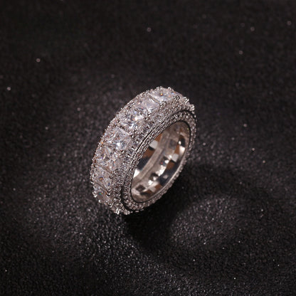 Silver tone round cubic zirconia wide band ring on black surface