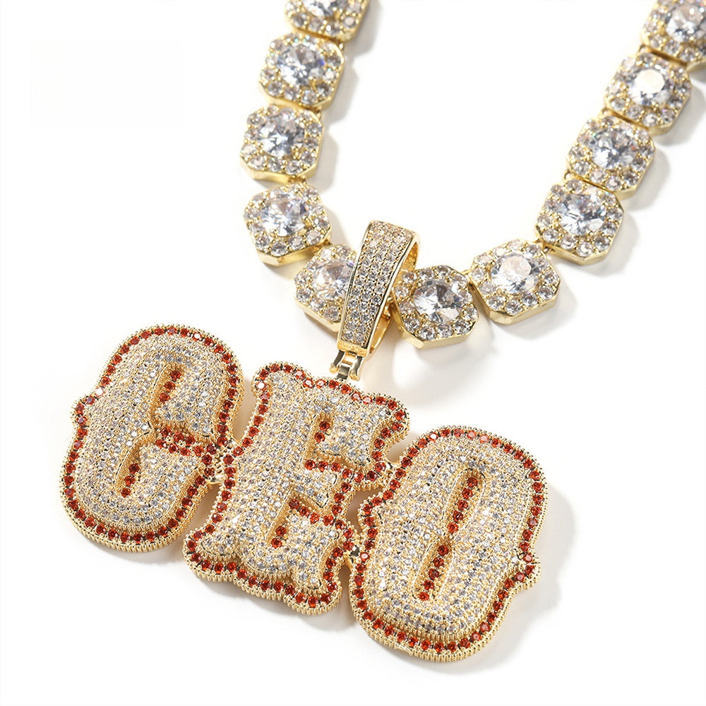 Gold-tone CHO bubble letter pendant with red stone edge product image