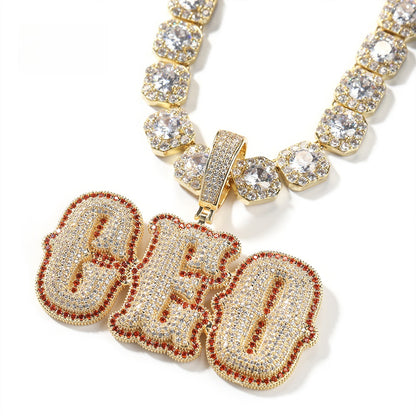 Gold-tone CHO bubble letter pendant with red stone edge