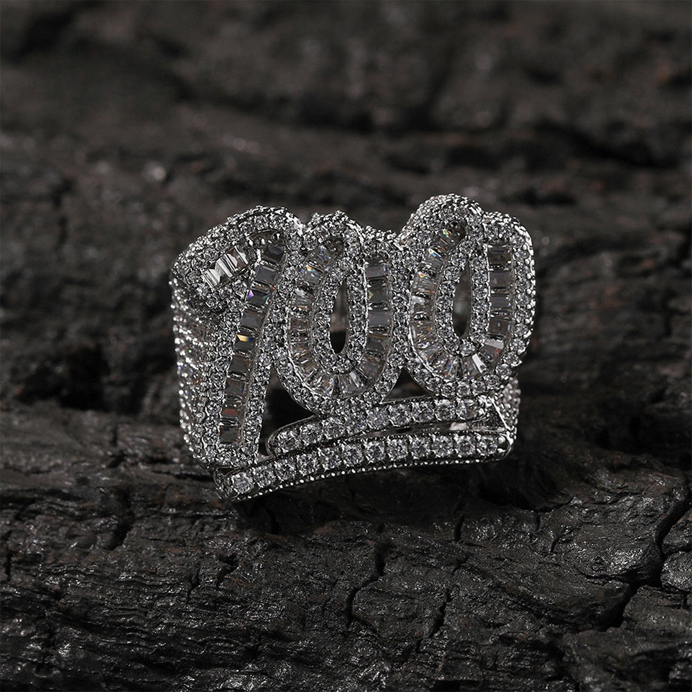 Silver tone number 100 cubic zirconia statement ring on dark stone product image