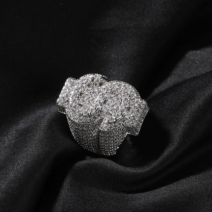 Silver tone coin-style cubic zirconia ring on black fabric