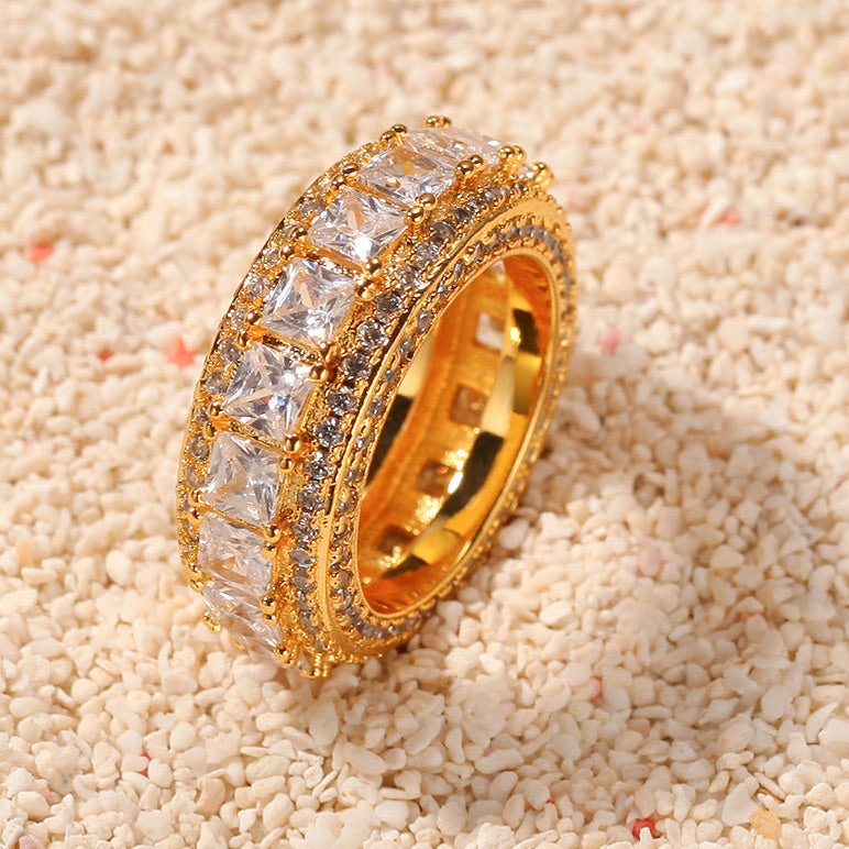 Gold tone square cubic zirconia band ring on textured surface product image