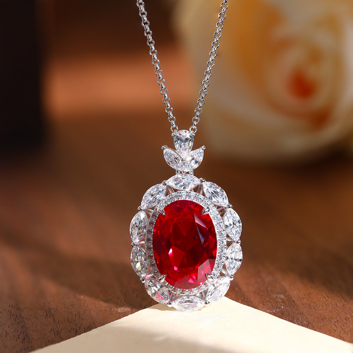 Blue Oval Floral Halo Pendant Necklace with Leaf Cluster Detail product image