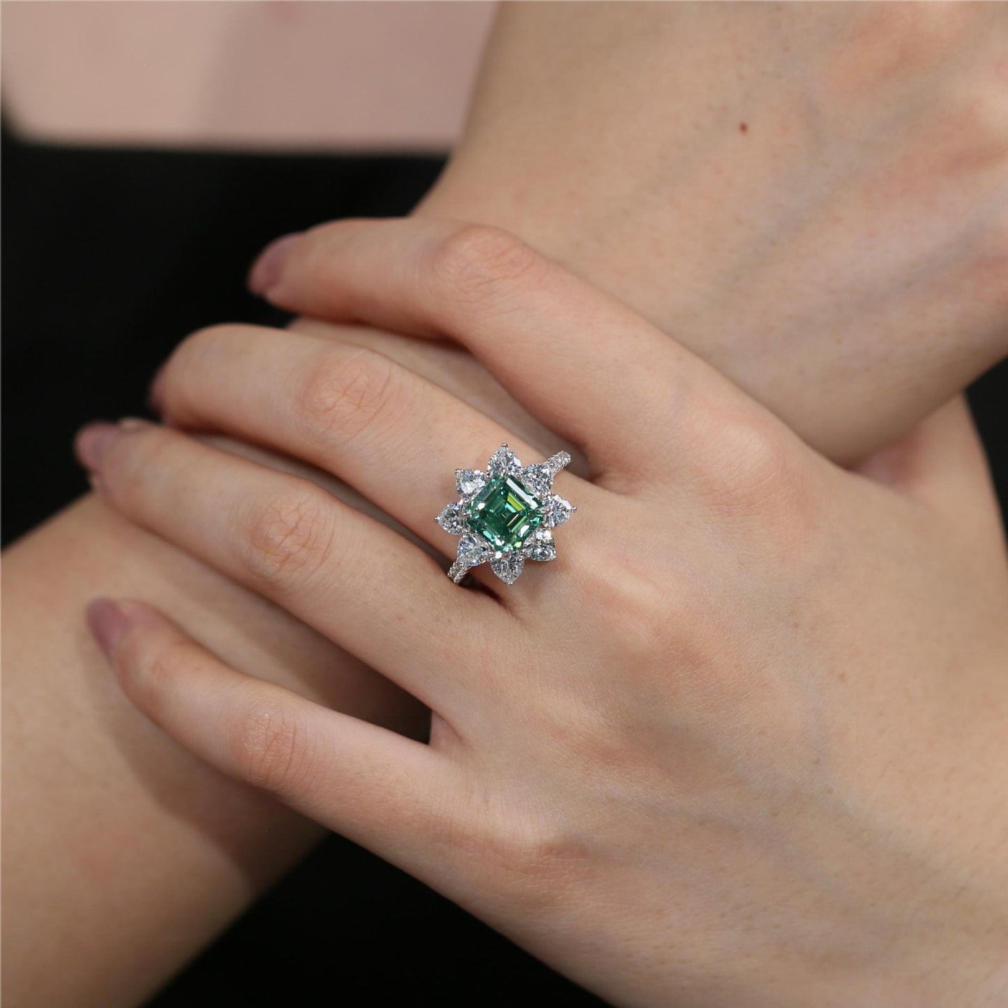 Asscher-cut green moissanite starburst halo ring shown on hand product image