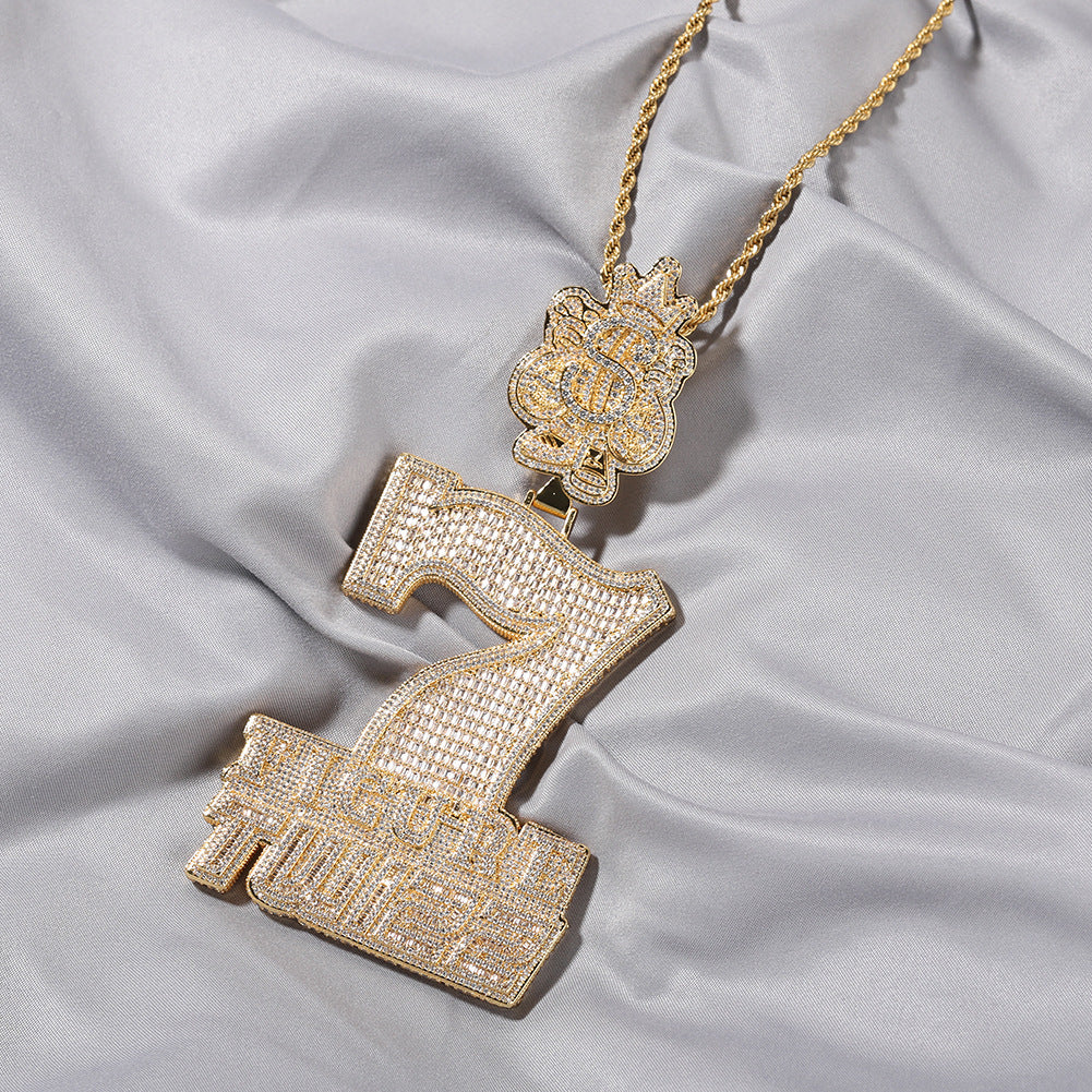 Gold tone number 7 cubic zirconia pendant necklace on white fabric product image