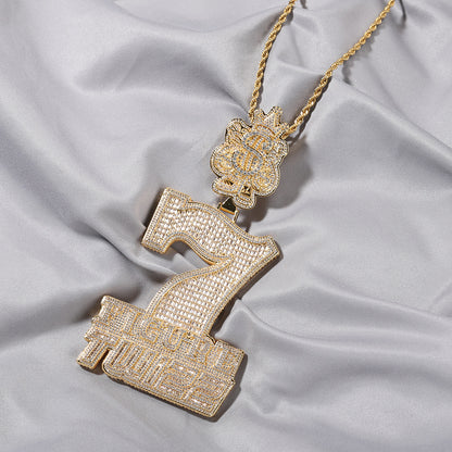 Gold tone number 7 cubic zirconia pendant necklace on white fabric